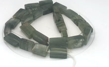 Load and play video in Gallery viewer, Natural graduated Rutilated Quartz strand | 20x11x6 - 15x8x5 | Green| Rectangle|