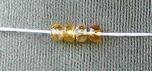 Load image into Gallery viewer, Natural 3.75x2.5mm Imperial Topaz Faceted Roundel Bead 54cts. Strand 106187 - PremiumBead Alternate Image 3

