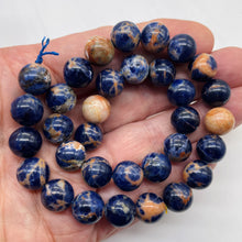 Load image into Gallery viewer, Blue Sodalite with White and Orange 12mm Round Bead 8 inch Strand 10781HS
