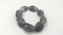 Load and play video in Gallery viewer, Misty Grey Tourmalated Quartz Bead 8&quot; Strand |20mm | Grey | Flat Oval | 12 Bds|
